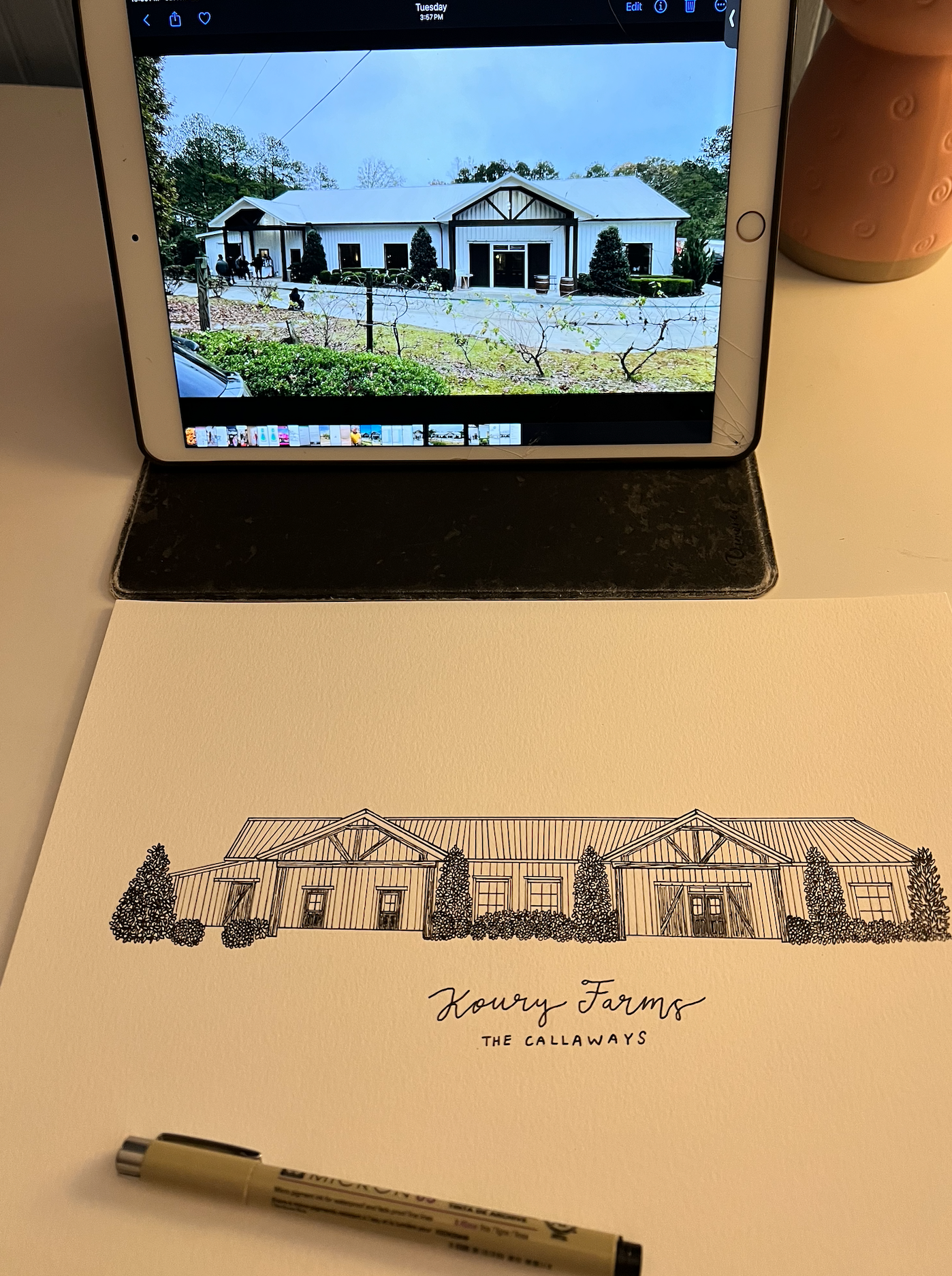 Custom house illustration being drawn while referencing a photo on a tablet device.