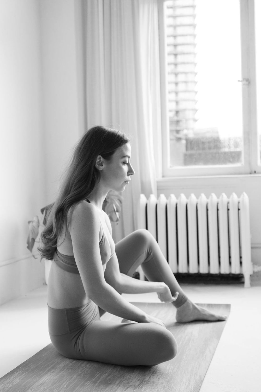 Series of artistic yoga poses photographed in a bright minimalist studio setting.