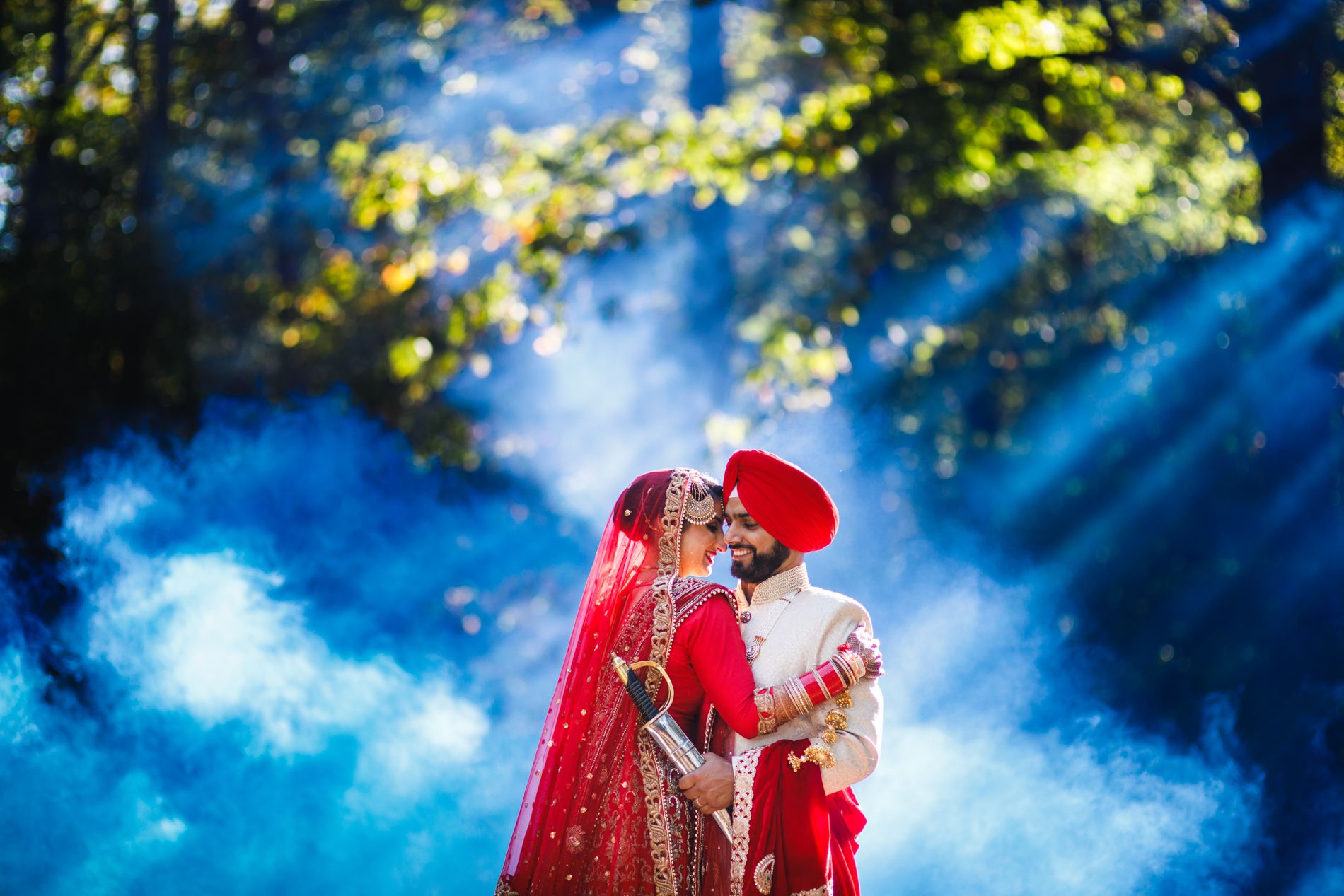 Romantic Sikh wedding at Fairview Park Marriott in Falls Church, bathed in dreamy blue light and forest glow.