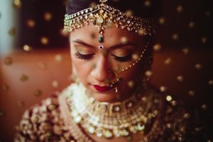 Close-up of a South Asian bride at Hilton Boston Woburn, adorned in traditional jewelry—timeless Indian wedding photography elegance.