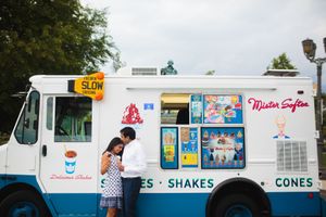Couple shares a kiss in front of a Mister Softee ice cream truck in Philly—fun, playful engagement photo by Zach Blum Photographer.