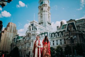 Stunning Indian wedding couple poses in front of Philadelphia City Hall near Crystal Tea Room – timeless South Asian wedding portrait!