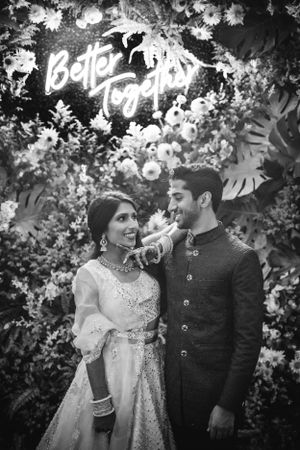 Romantic South Asian wedding portrait at Casa Cipriani in NY, featuring lush floral decor and elegant traditional attire.