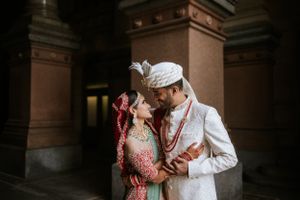 Elegant South Asian wedding portrait in Philadelphia, the couple shares a romantic moment framed by historic architecture.