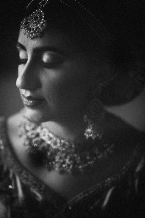 Elegant South Asian bride in timeless black and white, showcasing traditional jewelry and grace. Bridal portrait in New Jersey wedding.