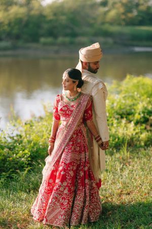 Romantic South Asian wedding couple by the water at Chase Center on the Riverfront—elegant outdoor bridal portrait.