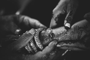 Close-up of intricate bridal mehndi and bangles during an Indian wedding at the Crystal Tea Room, captured in timeless black and white.
