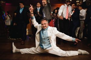 uncle steals the spotlight with an epic split on the dance floor at Birchwood Manor Indian wedding — unforgettable party moment!