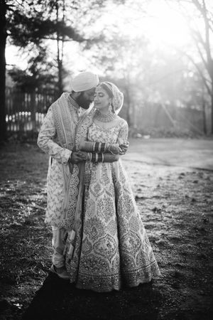 Romantic black and white portrait of a South Asian bride and groom sharing an intimate moment at golden hour in New Jersey.