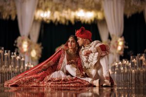 South Asian bride and groom share a quiet moment under a floral mandap at The Marigold in Somerset, NJ, surrounded by candlelight.