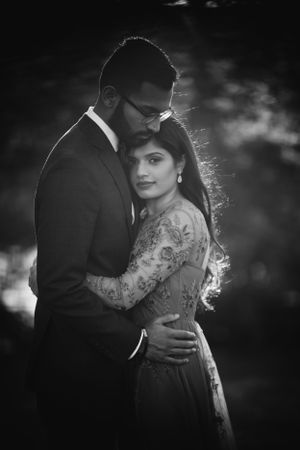 Romantic black and white engagement portrait of a South Asian couple embrace in Philadelphia captured with soft light and timeless elegance