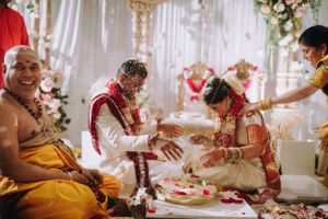 Traditional South Indian wedding ceremony at The Legacy Castle in NJ, with couple performing rituals under a floral mandap.