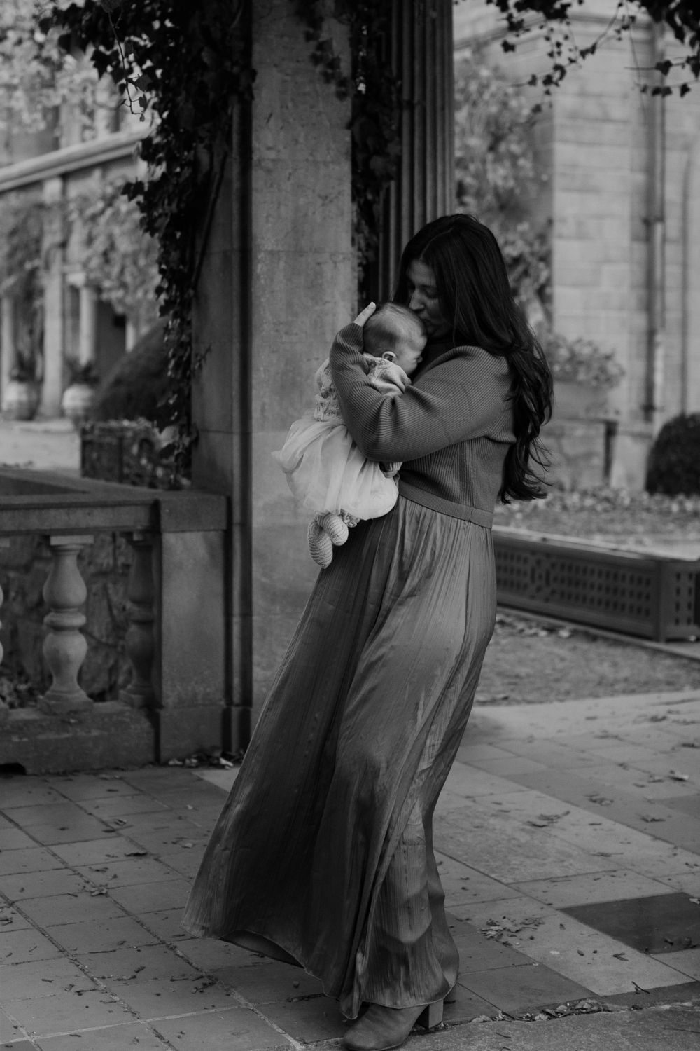 Elegant black and white portrait of dancing on classic stone veranda.
