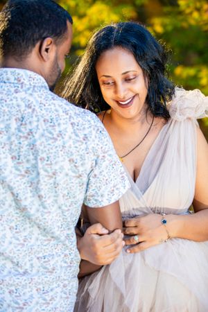 A tender moment captured between a couple during an outdoor photoshoot.