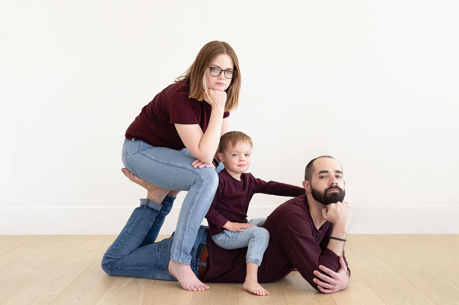 family of three doing a silly pose