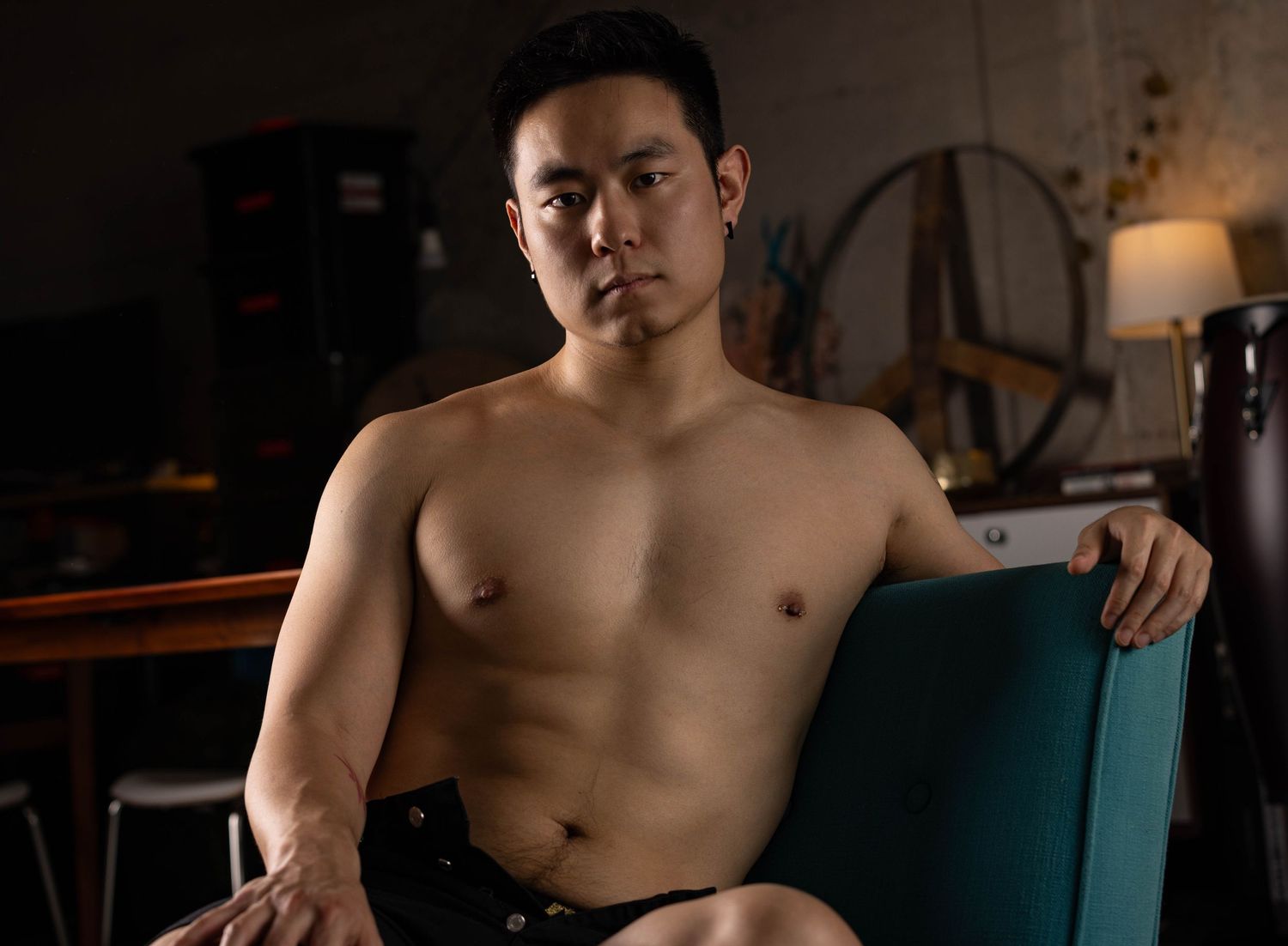 Photo of shirtless man in living room during boudoir photo shoot in Los Angeles.