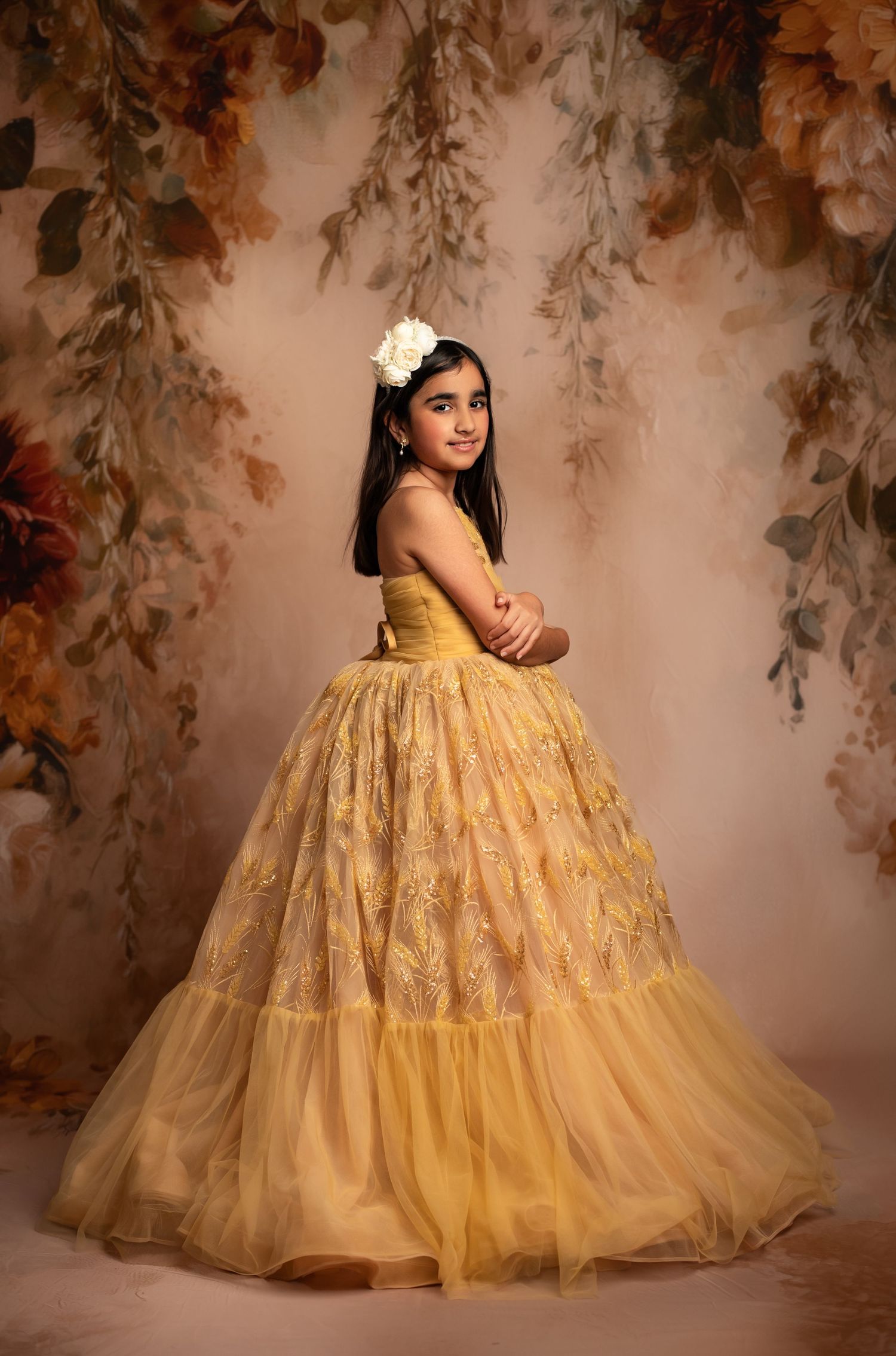 A figure in a flowing yellow dress stands among golden wheat fields at sunset with dreamy ethereal lighting.