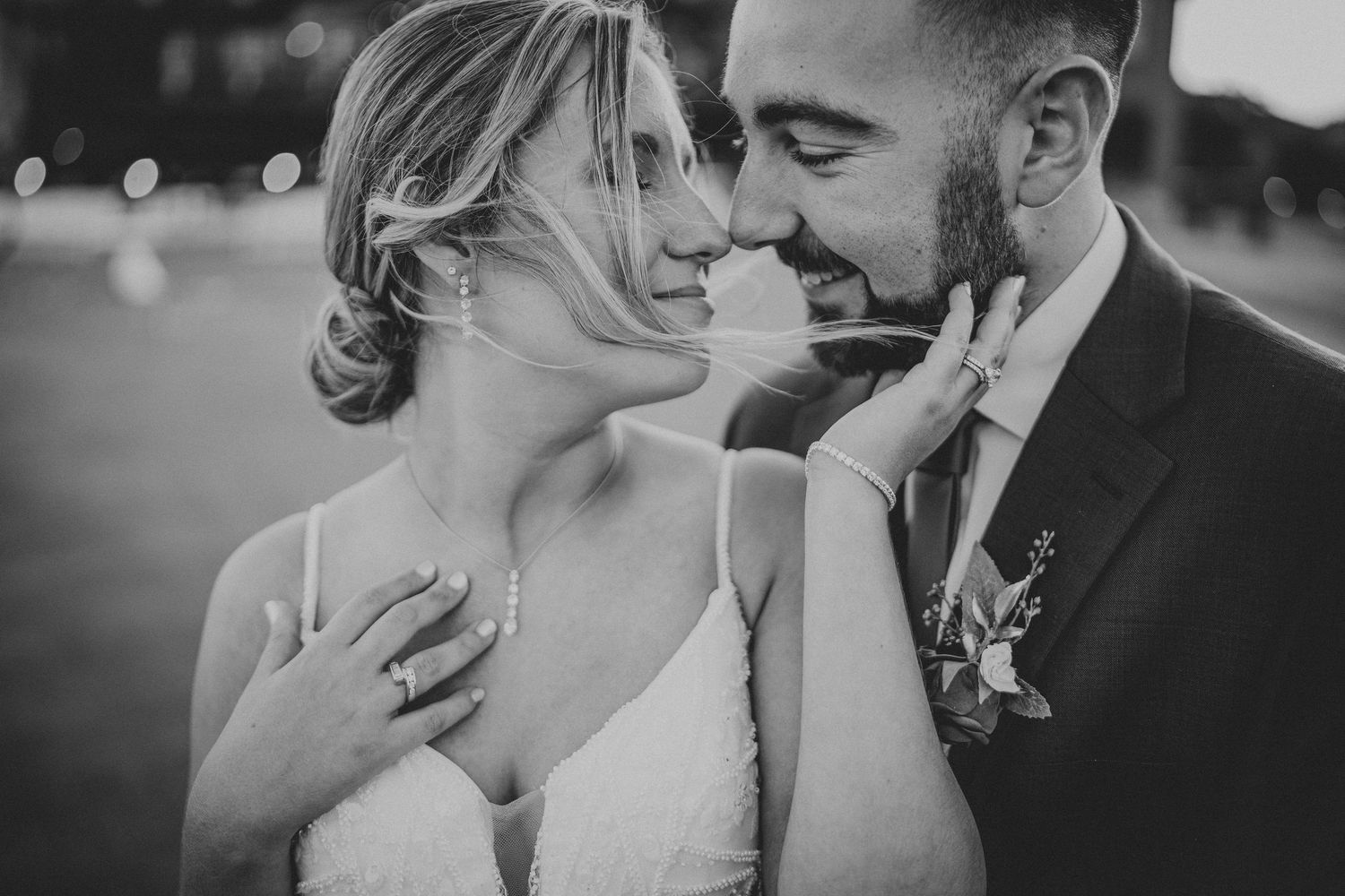 A romantic black and white wedding photo series showing tender moments between a couple on their special day.