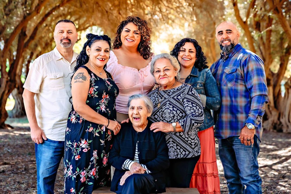 Three generations smiling together during a multi-generational family portrait in Fresno by Colibrí Captures.