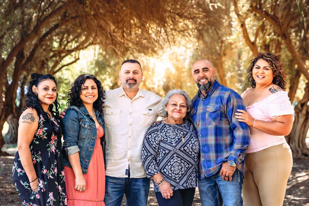 mom sharing a joyful embrace with her children during a lifestyle family session at Kearney Park in Fresno.