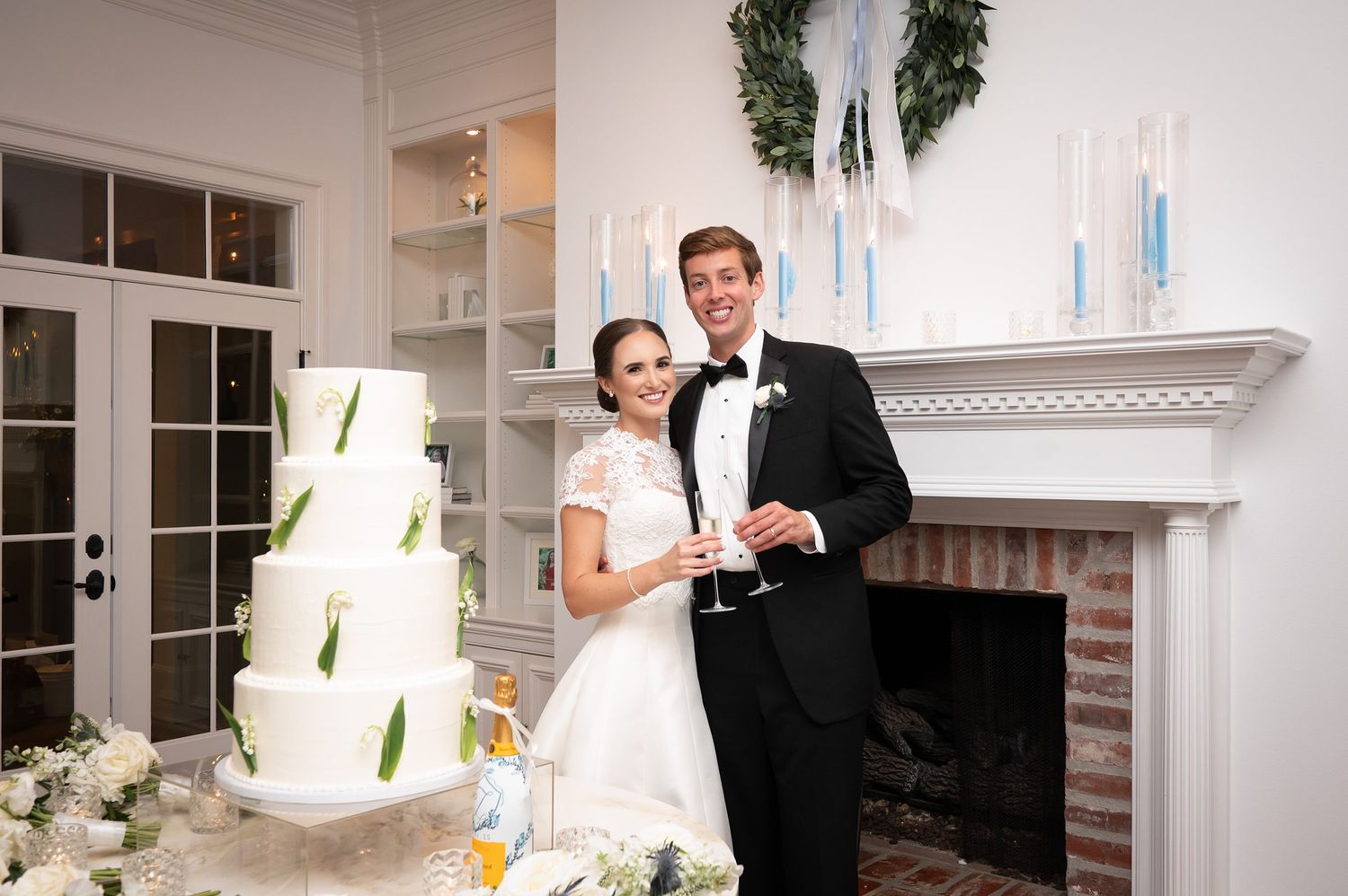 Elegant indoor wedding reception scene with white decor and romantic lighting.
