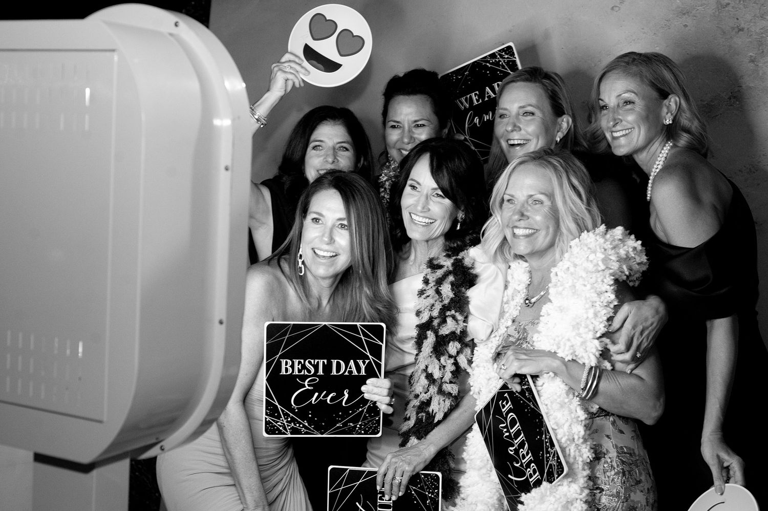 Wedding party celebrating with props and photo booth accessories.