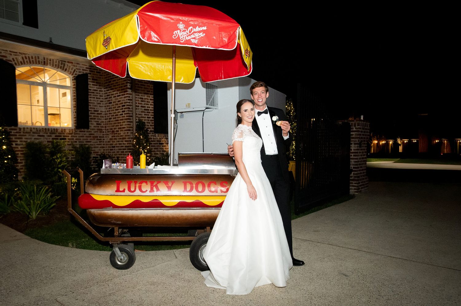 Wedding reception with vintage food truck and outdoor lighting.