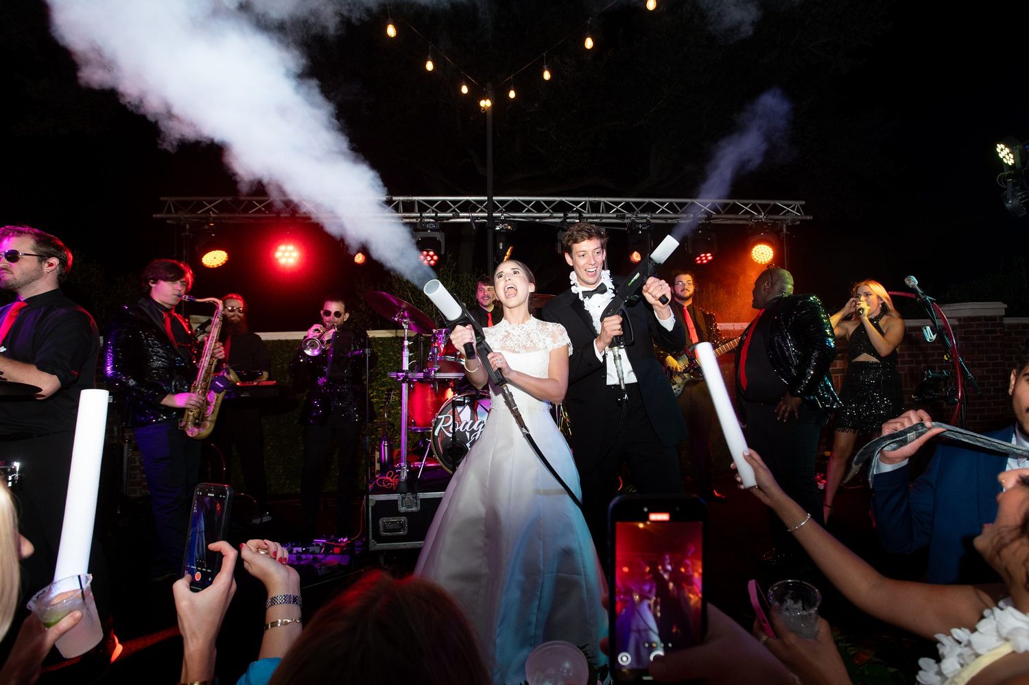 Dance floor with fog effects and colored lighting at wedding reception.