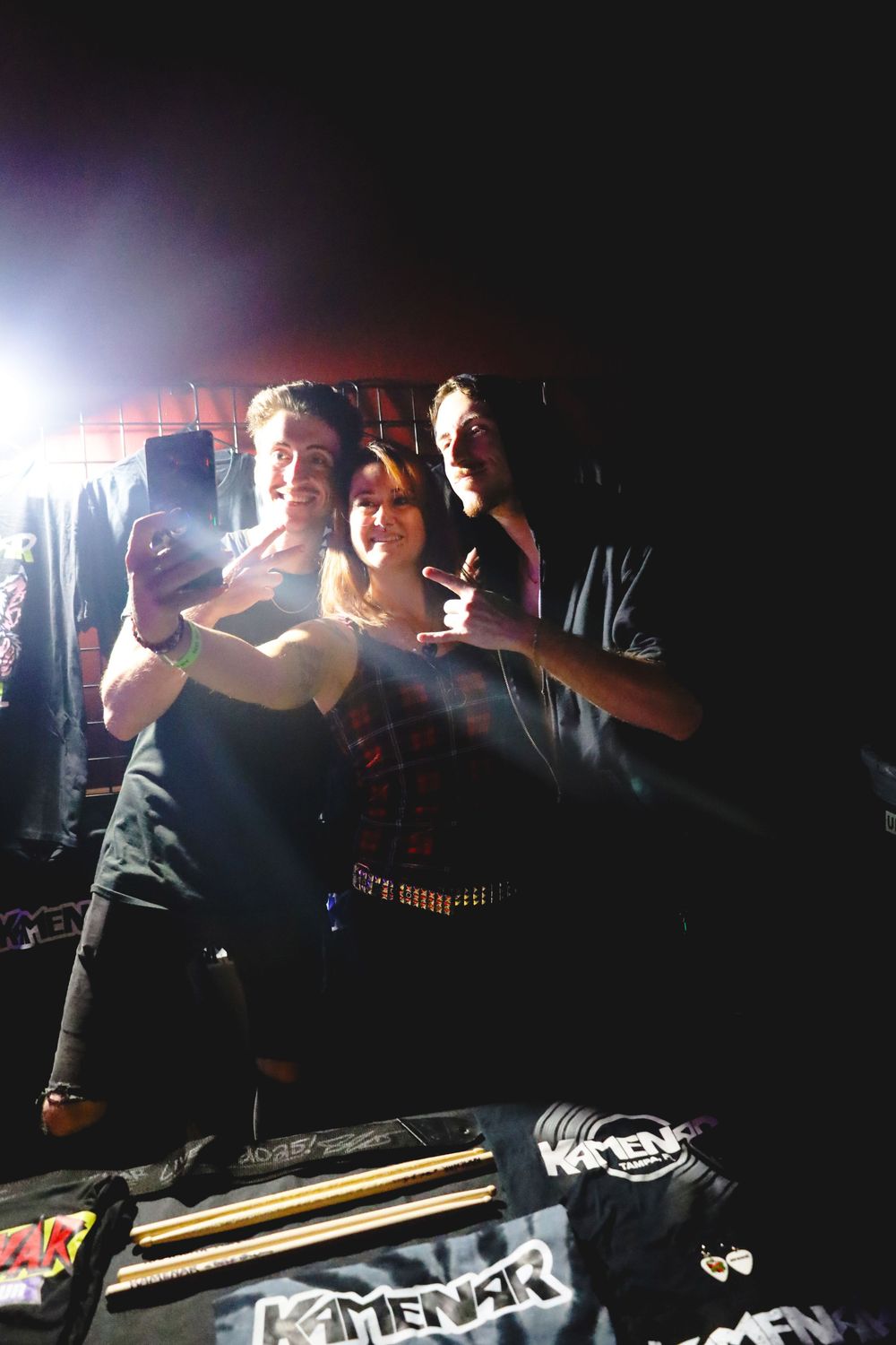 People dancing and having fun in a dark nightclub with dramatic lighting effects and silhouettes.