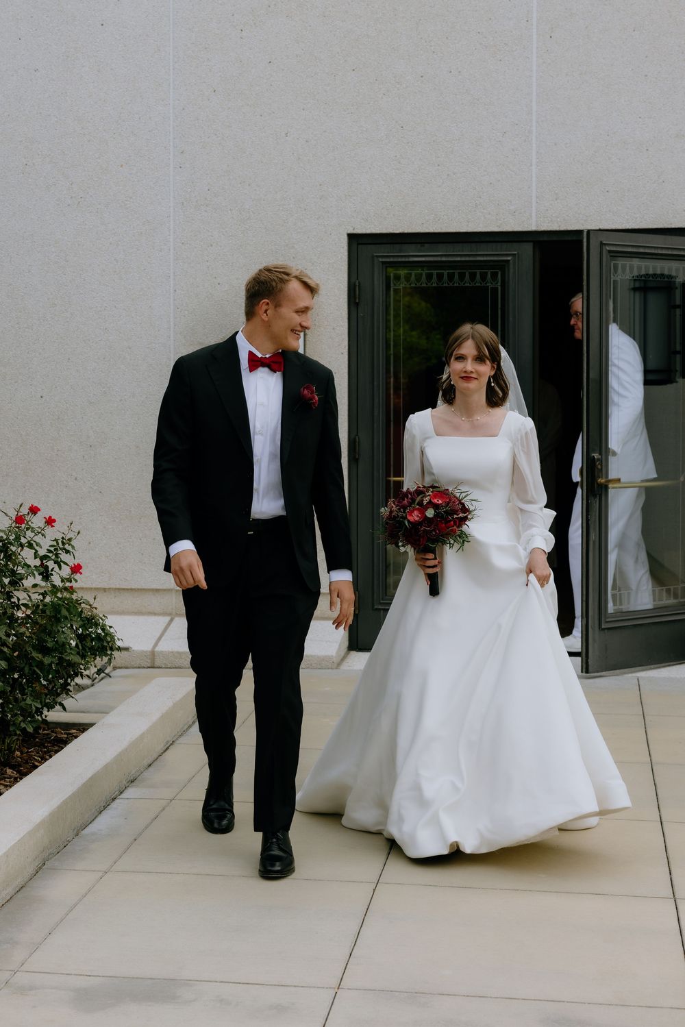 A sequence of wedding photos showing a couple walking together on a light-colored stone patio with rose bushes in the background.
