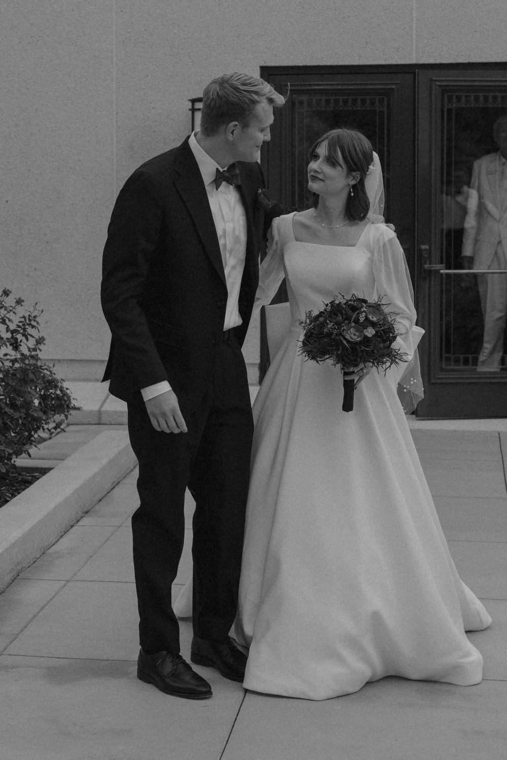 Black and white wedding photo series showing a couple in formal attire during an intimate outdoor moment.