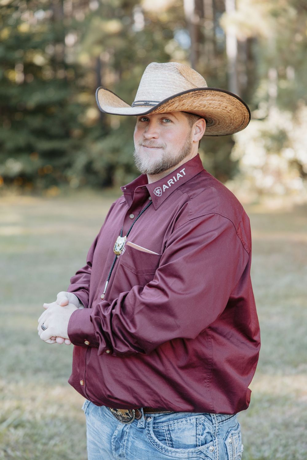 Person in western wear striking different poses outdoors against natural backdrop.
