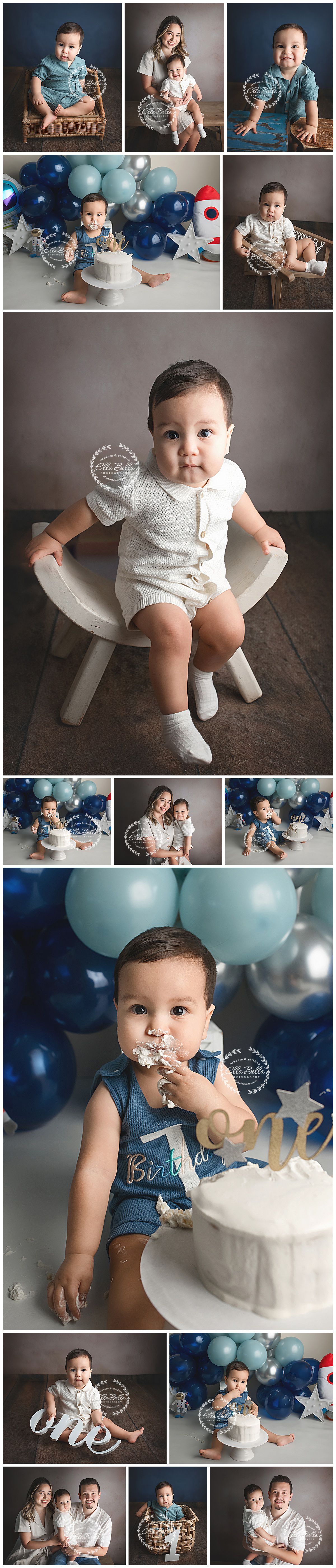 First birthday cake smash photo session with blue and silver balloons and white cake decorations against grey backdrop.