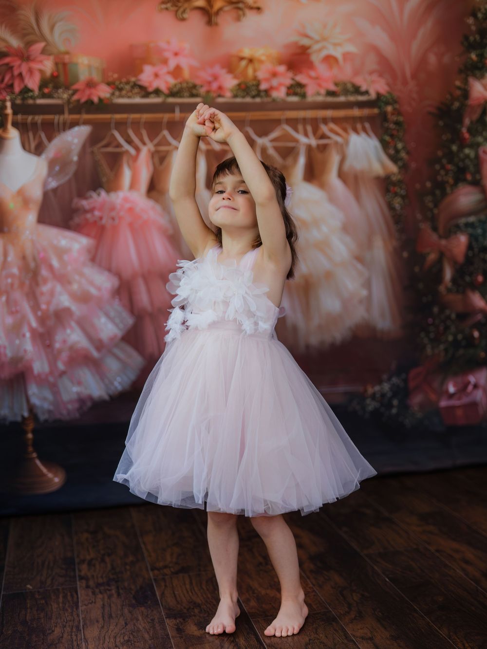 A series of dreamy photos showing pink tulle ballet dresses against a romantic floral backdrop on a rustic wooden floor.