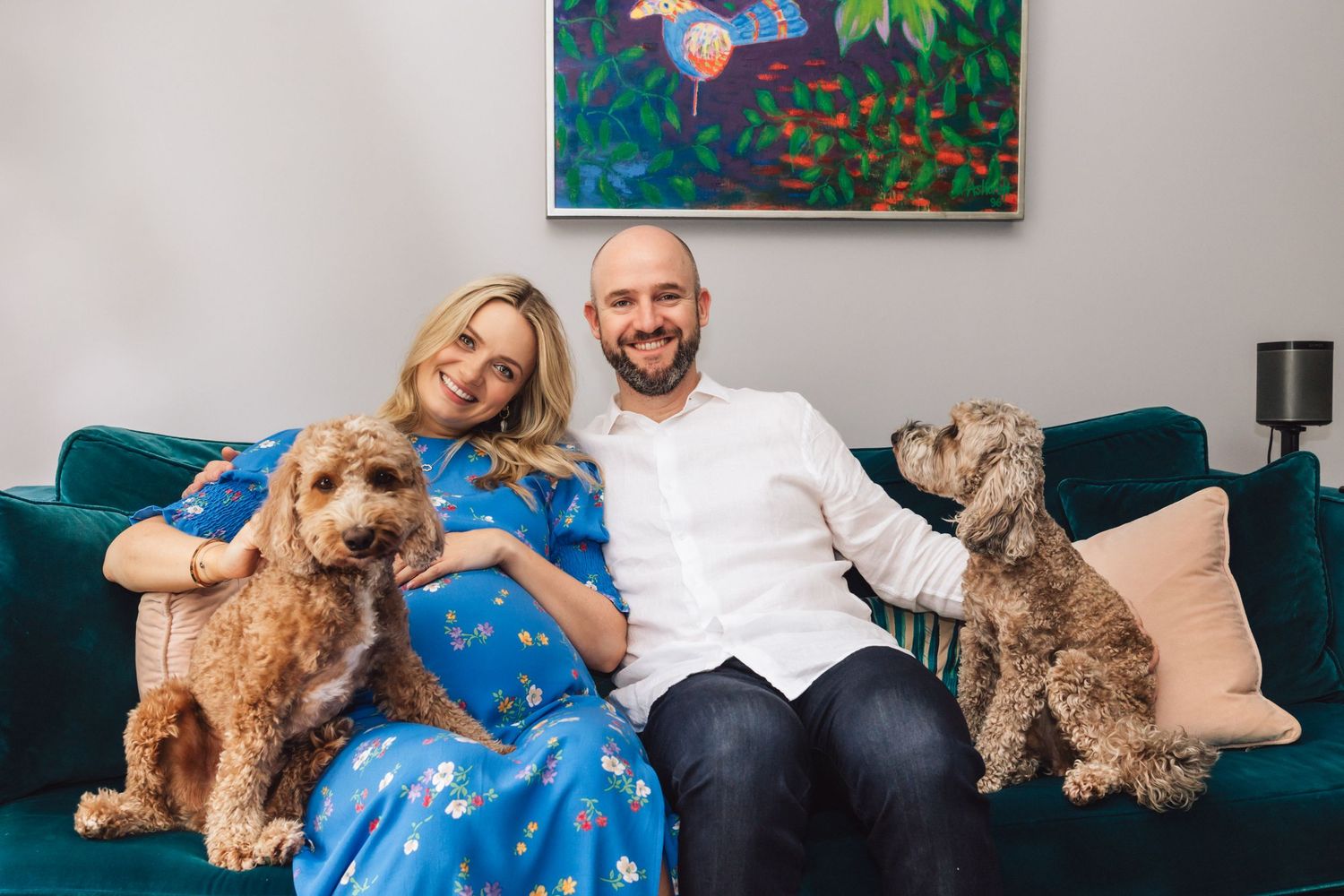 Pregnant lady on couch with husband and dogs