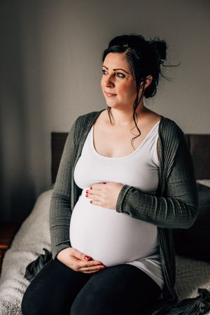 pregnant mum looking out window