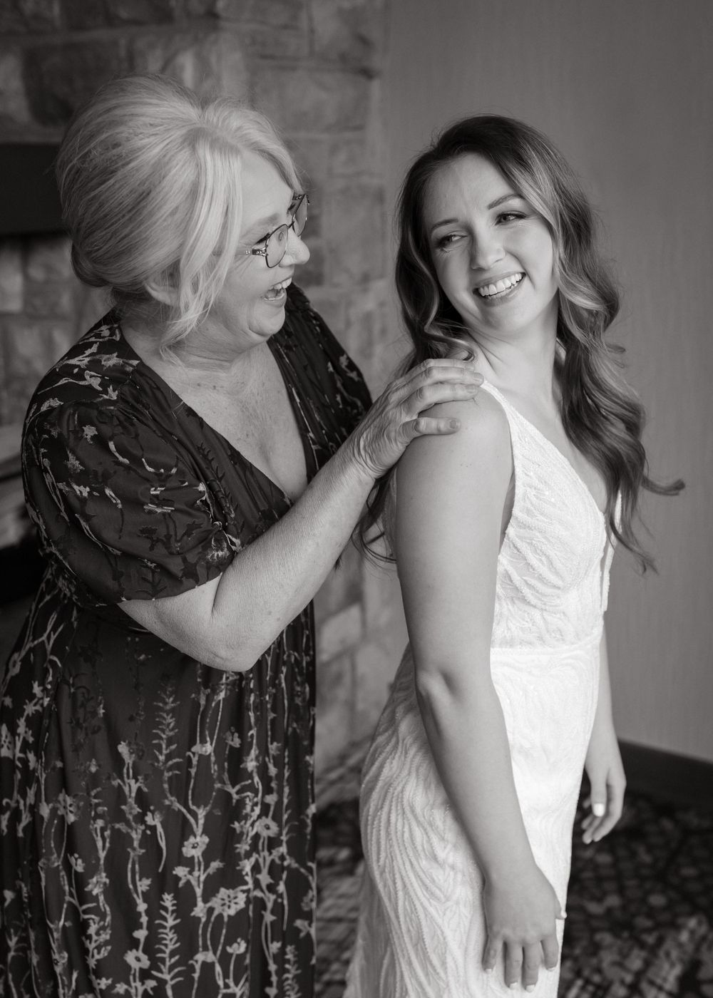 Black and white candid sequence showing emotional moments between two women in formal attire.