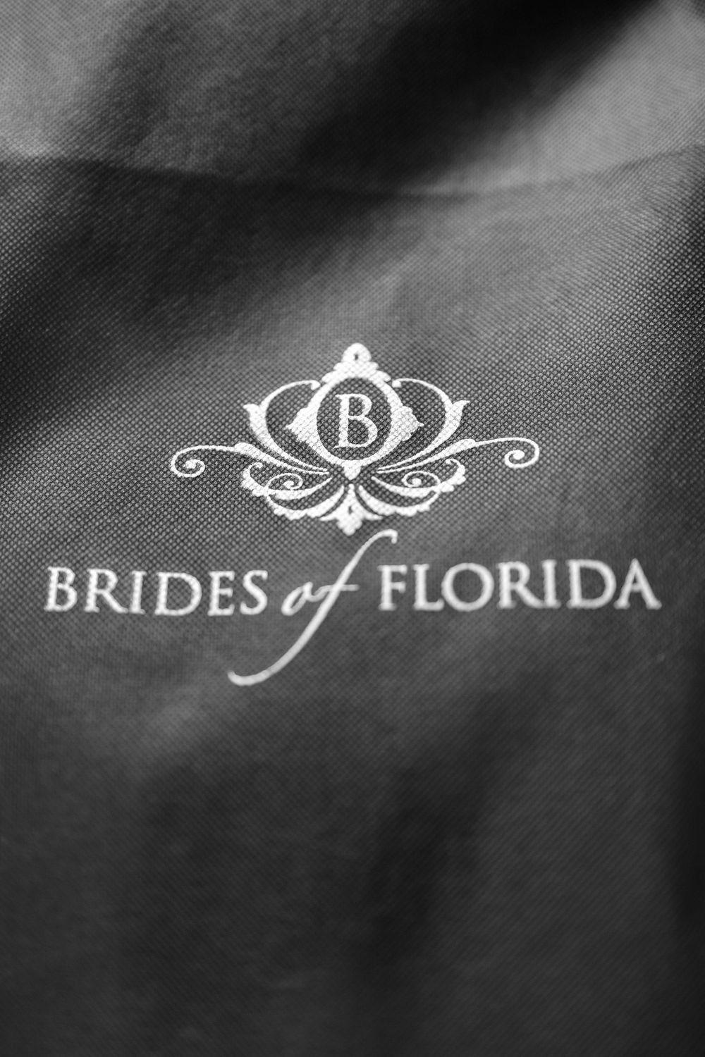 Elegant black and white Brides of Florida logo design with decorative flourishes.