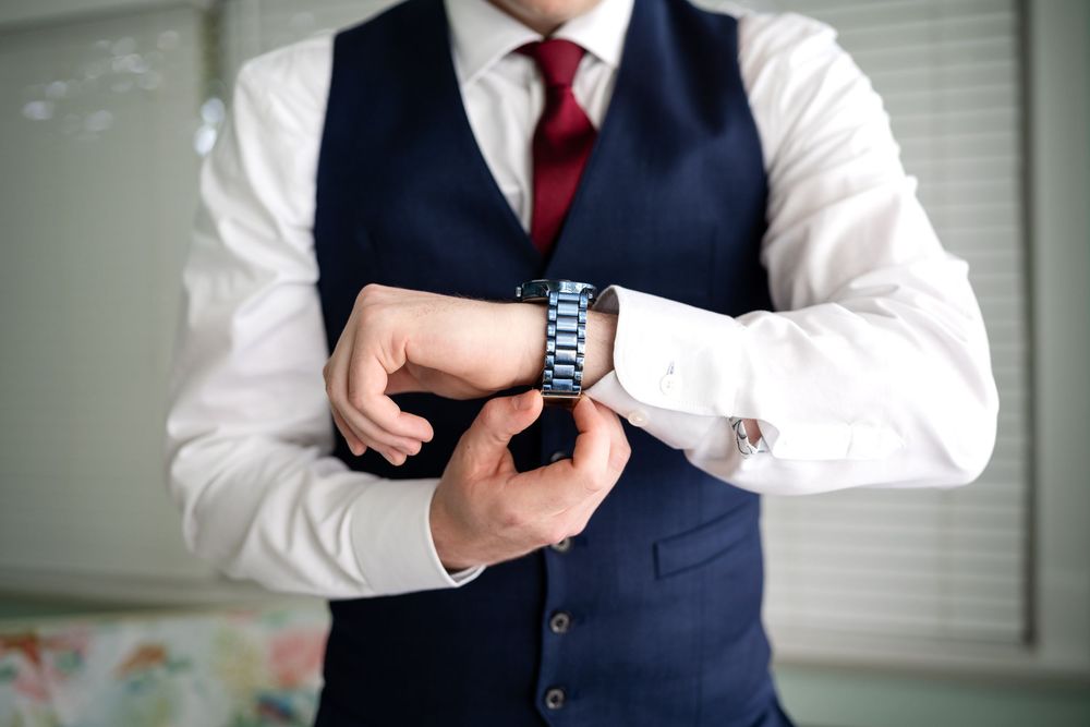 Detail shots of groom getting ready, focusing on formal attire and accessories.