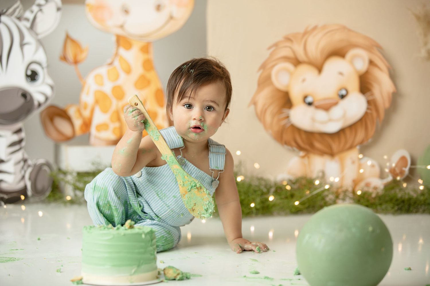 Baby enjoying first birthday cake smash in Springfield Lakes photography studio.