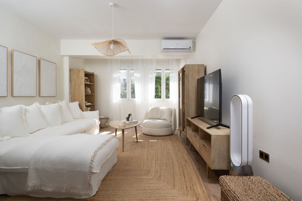 Modern minimalist bedroom interior with white walls, wooden flooring, and built-in storage features natural lighting.