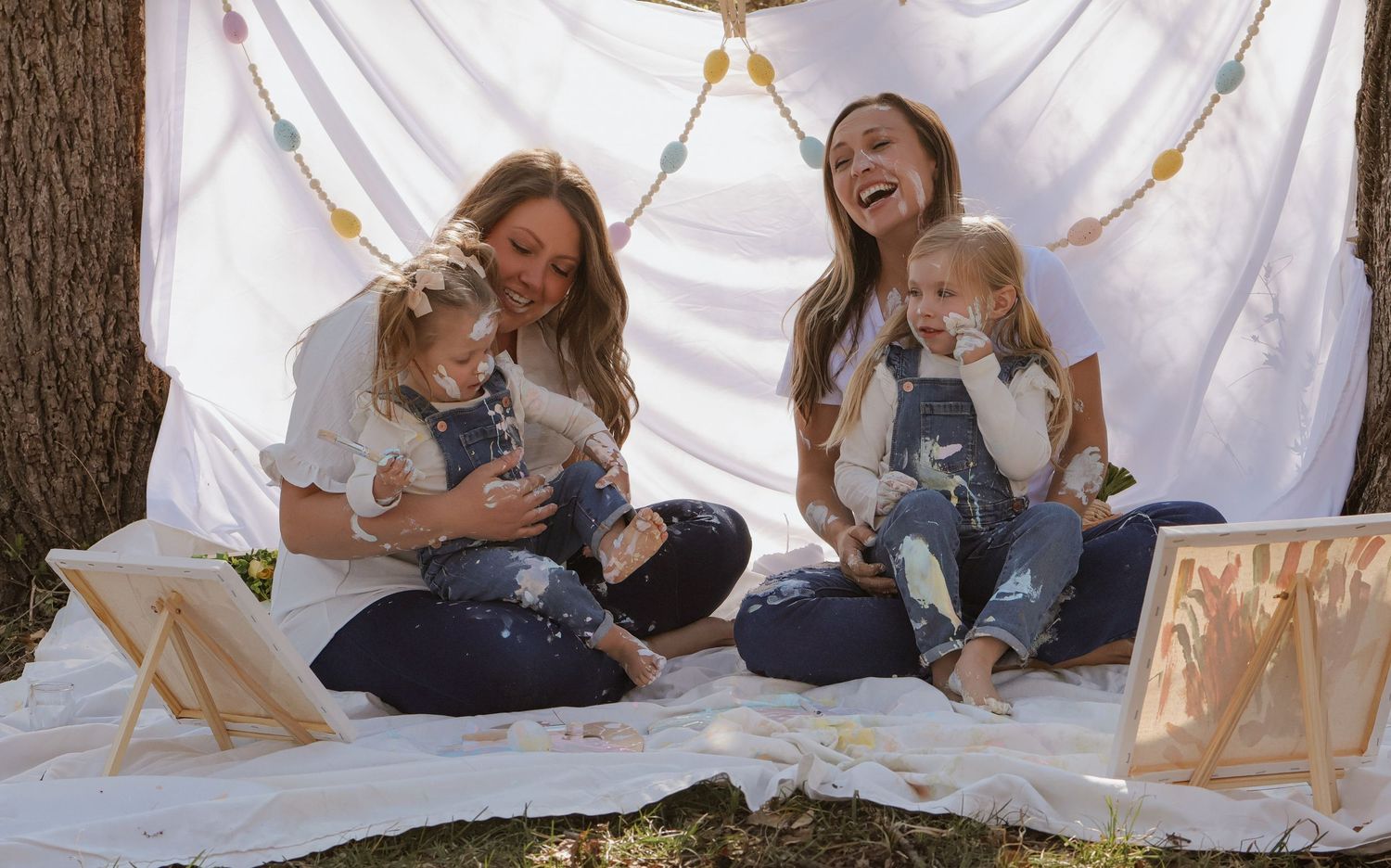 Lifestyle photography session with white backdrop showing playful family moments.