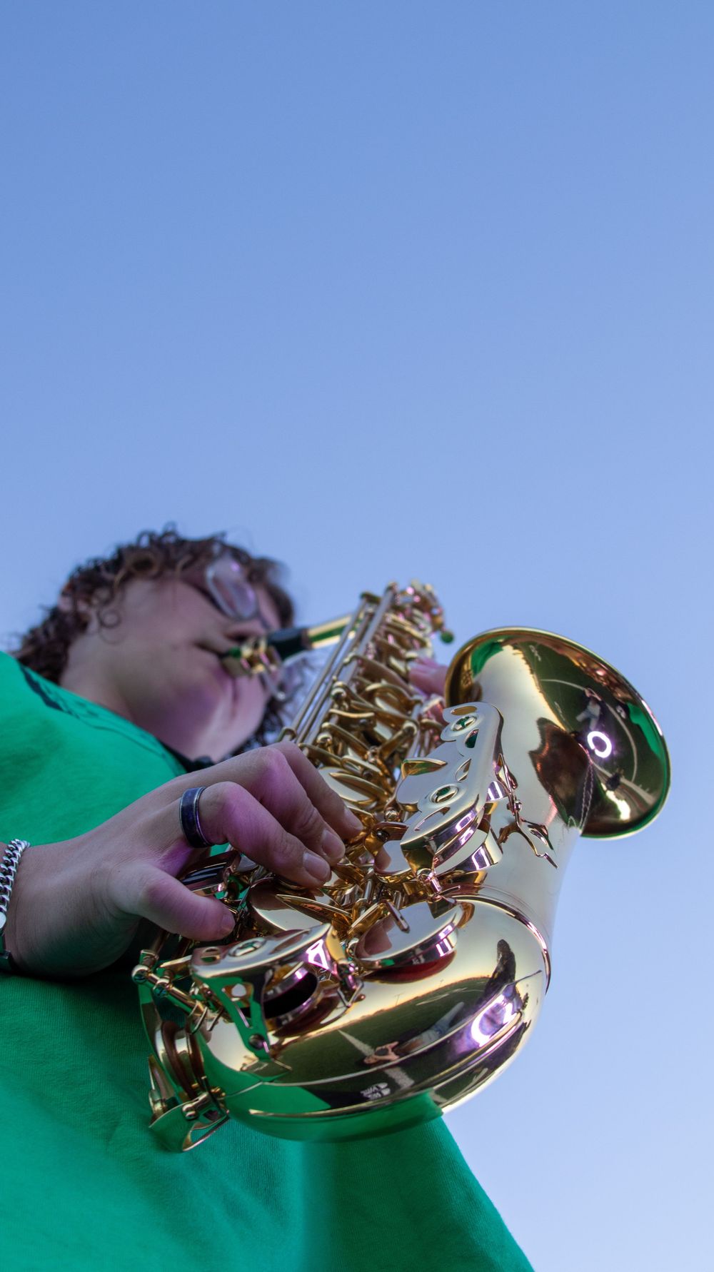 Teen boy playing saxophone during a creative senior photography session