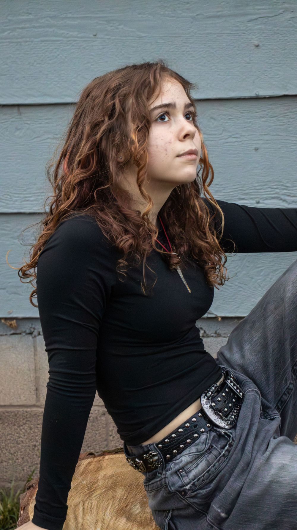Teen girl sitting outdoors during a candid identity photo session in Utah
