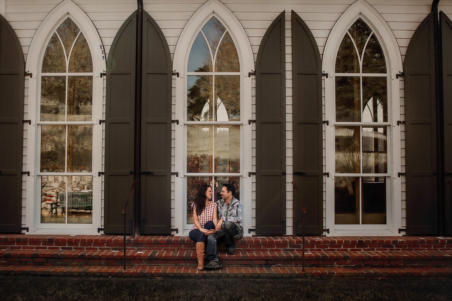 Couple holding hands in front of chapel in Branson MO.