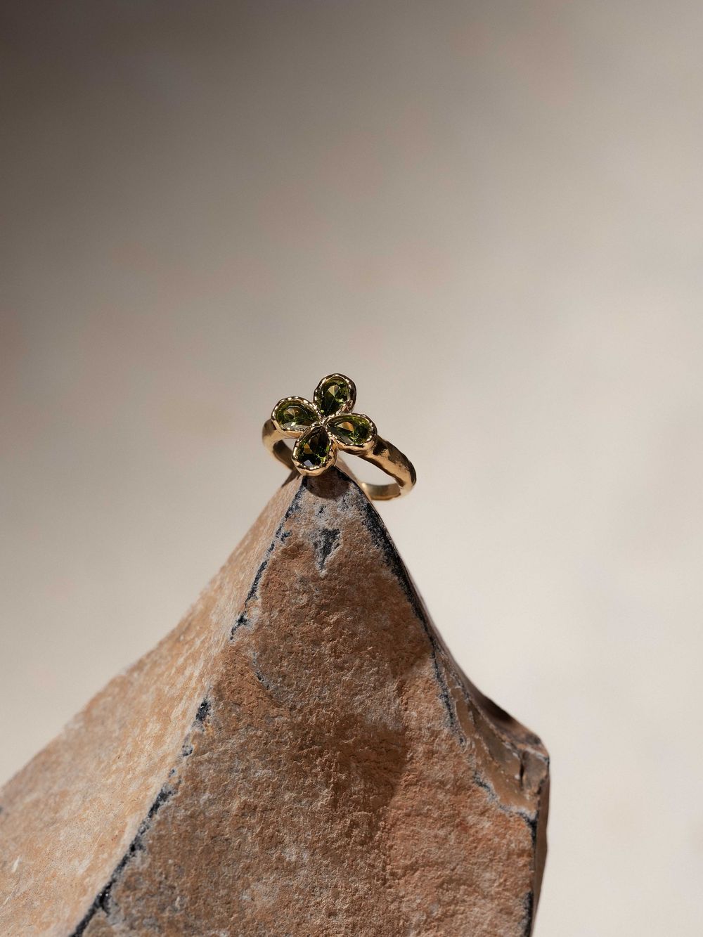 A sequence of macro photos showing a small bee landing and perching on the tip of a rusty brown metal surface.
