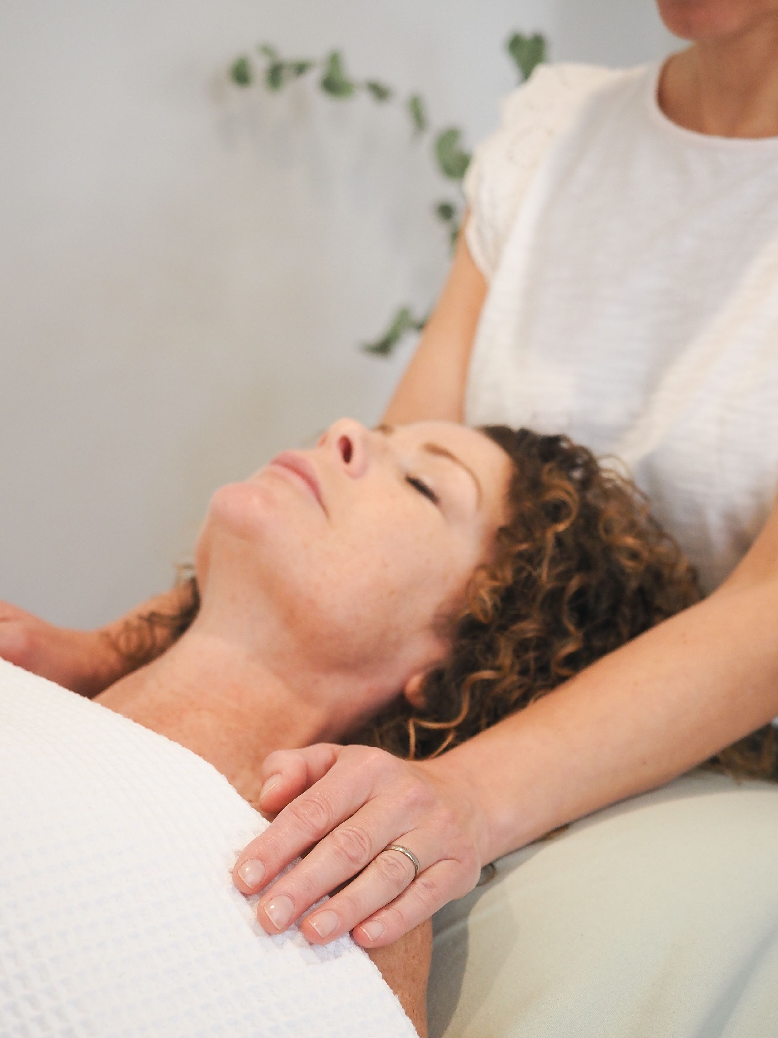A person receives a relaxing neck massage during a therapeutic spa treatment session.