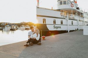 Panoramic view of a white riverboat docked at sunset.