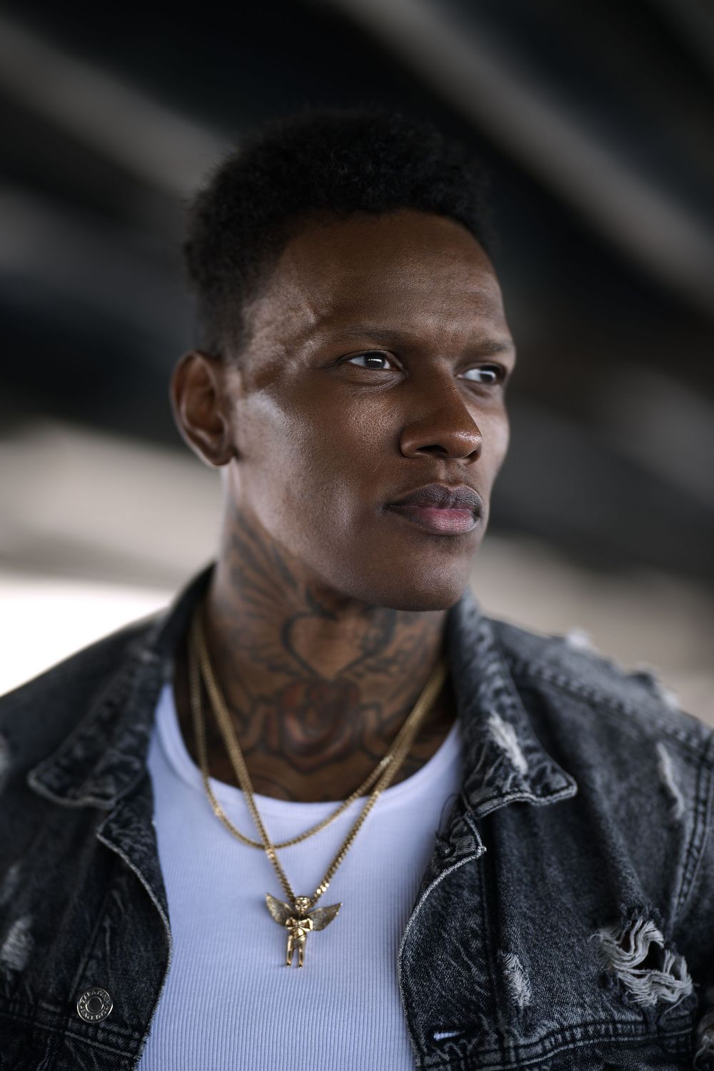 Close-up portrait series of a person wearing a white t-shirt, denim jacket and gold necklace against dark background.