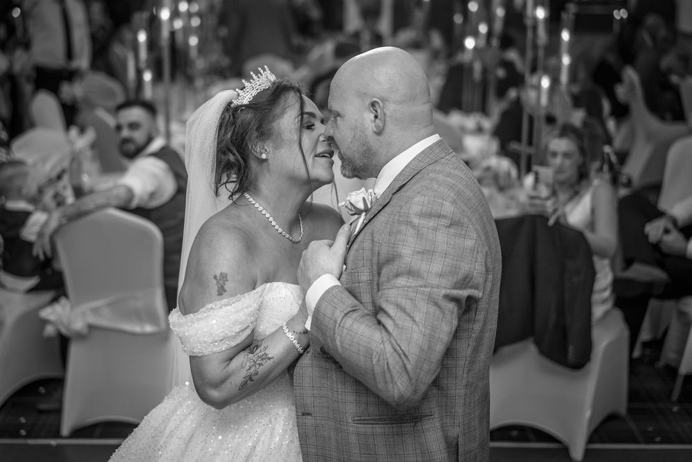 Black and white portrait of a couple sharing an intimate moment during their first dance.